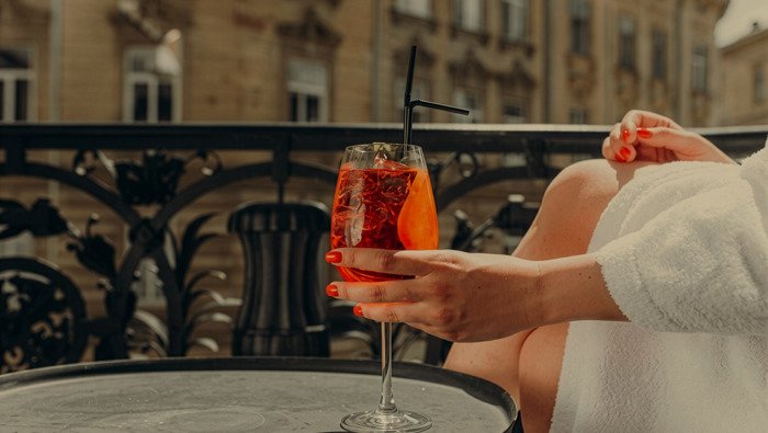 Woman drinking cocktail on terrace