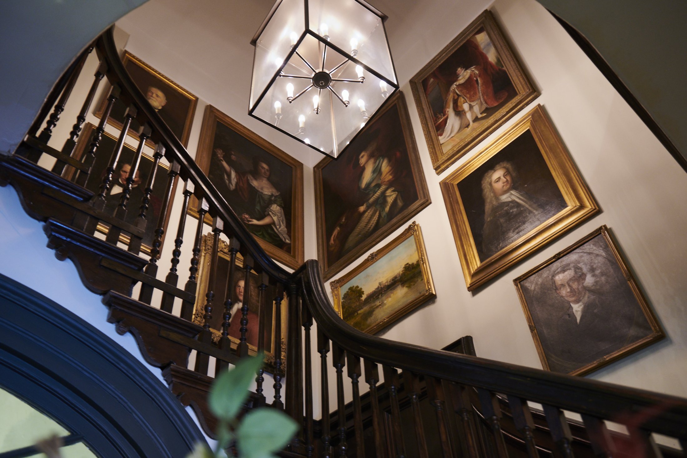 portrait paintings on staircase