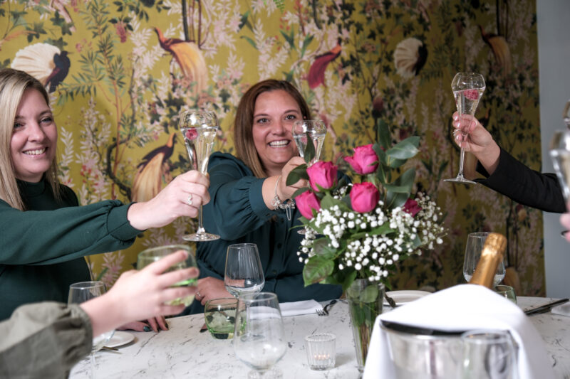 Maple room with people clinking glasses