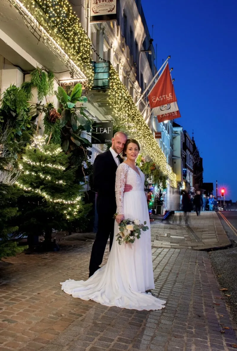 Bride and groom outside at night time with Christmas decorations
