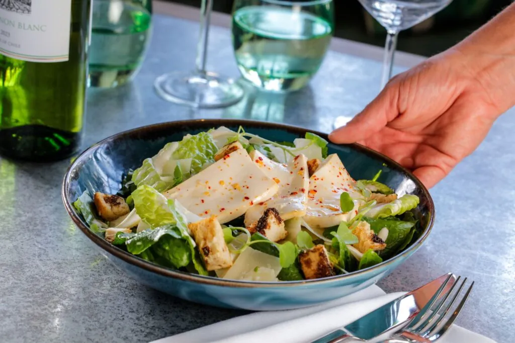The Castle Hotel Windsor putting down tofu caesar salad