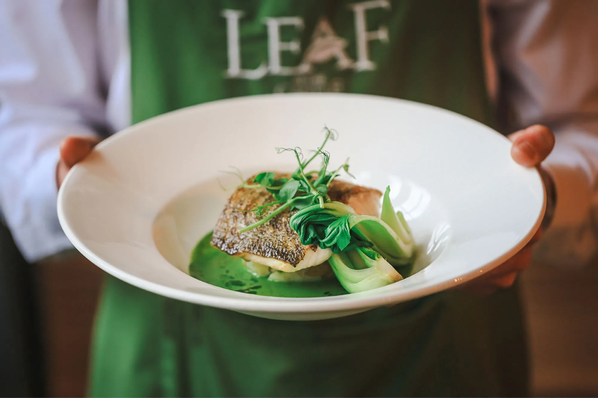 The Castle Hotel Windsor waiter holding baked cod loin